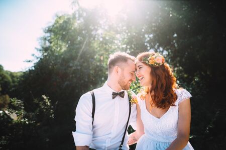 Attractive couple laughing on a sunny day. Over them the rays of the sunの写真素材