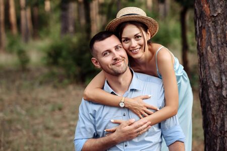 Portrait of a beautiful couple in love in summer stylish clothes on the natureの写真素材