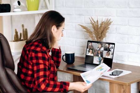 Business meeting online. Business team working from home in a video conference. 
The girl...