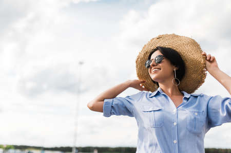 Amazing caucasian young woman dressed in stylish casual clothes, wearing a hat and sunglasses poses...