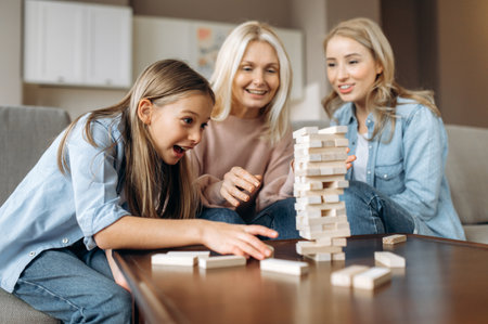 Funny weekend leisure family time. Cheerful caucasian happy grandma daughter and granddaughter...
