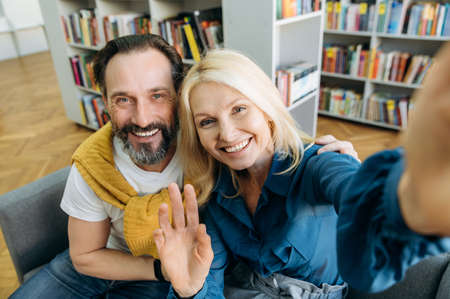 Friendly mature business people taking a break from work, doing a selfie. Happy successful coworkers in stylish wear looking directly at the camera, smiling, partnership conceptの写真素材