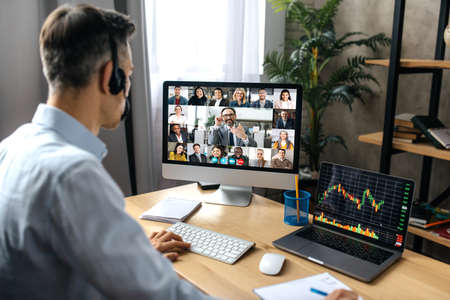 Virtual meeting, video call. Successful adult businessman have conversation with multiracial...