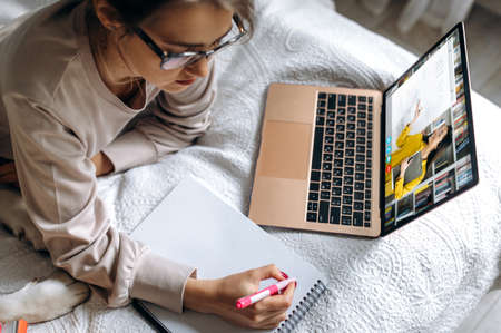 Online lecture during distance learning, on the screen female teacher explains the topic of the...