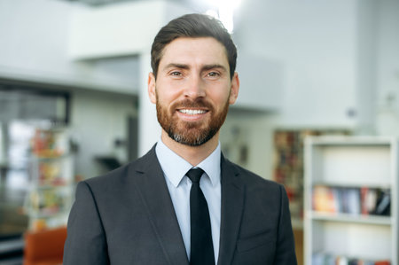 Close-up portrait of a positive successful intelligent influential bearded caucasian businessman,...