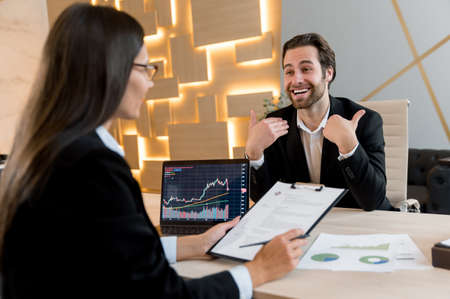 Business woman, company director, hiring specialist in a trading company, sits at a desk in front of...