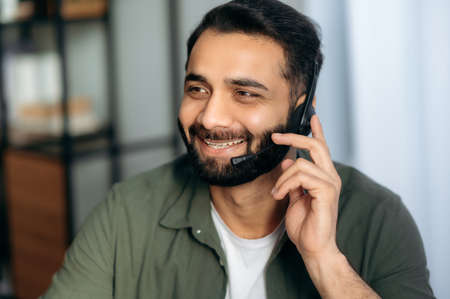 Support service concept. Close-up of friendly pleasant attractive Indian or Arabian man with...