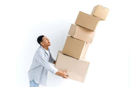 Stunned mixed race guy in casual stylish clothes, delivery man, standing over isolated white...