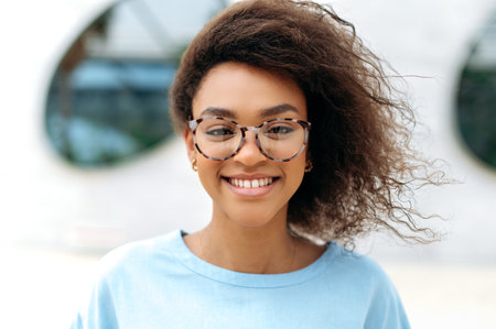 Close-up photo of a confident successful lovely positive young curly haired African American...
