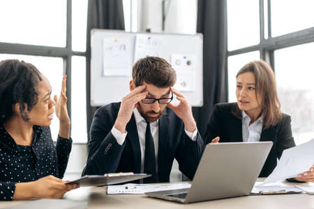 Quarrel in the work team. Irritated business employees of different nationalities, work at the...