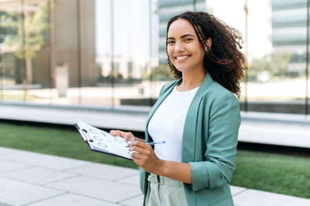 Portrait of a successful smart business woman, brazilian or hispanic nationality, financial...