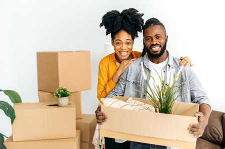 Portrait of a modern happy african american couple in love, husband and wife, moved to their new...