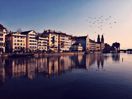Swiss lake with buildings reflected in the waterの写真素材