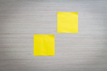 Yellow sticky note attach to a wooden wallの写真素材