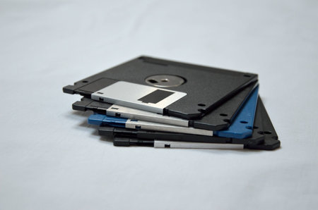 Stack of old magnetic Diskettes on white backgroundの写真素材