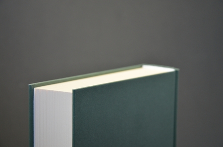 Detail view of upper part of green empty book on black backgroundの写真素材