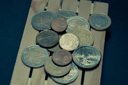 Retro vintage photo effect of euro coins money on the pallet. Prepared for transport. Macro photo...