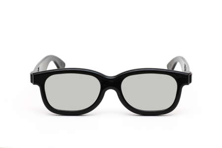 Front view of black plastic glasses to watch films in 3D format isolated close up on white...