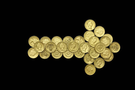 Pointer  made of one pound english sterling coins isolated on black backgroundの写真素材