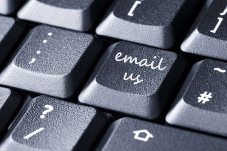 Close up of black computer keyboard with email us sign on a buttonの写真素材