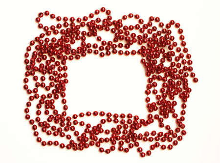 Red bead chain christmas decoration arranged as a frame isolated on white backgroundの写真素材