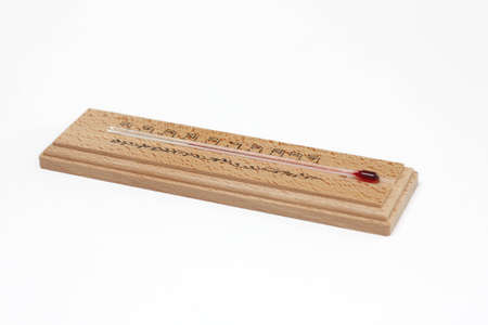 Close up of wooden thermometer isolated on white background