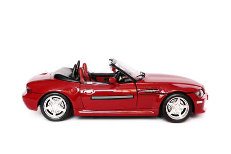 Red BMW convertible toy car on white backgroundの写真素材