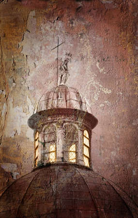 Roof of an ancient church with stone statue and cross in grunge styleの写真素材