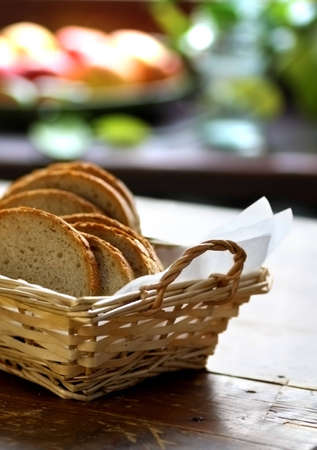 White bread sliced in woven basket placed on table