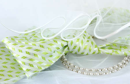 Close up of green groom tie with white veil and bridal necklaceの写真素材