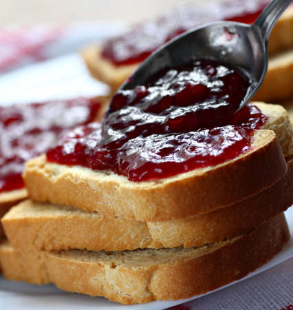 Sandwiches with white bread spread with homemade cherry jamの写真素材