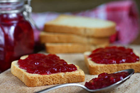Sandwiches with white bread spread with homemade cherry jamの写真素材