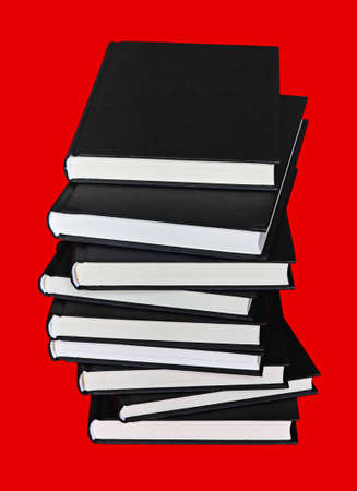 Close up of large pile of books with black cover over red backgroundの写真素材