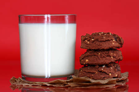 Close up of glass filled with milk and stack of cookiesの写真素材