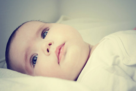 Close up of pretty infant face looking happyの写真素材