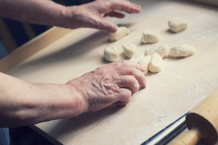 Close up of female hands making doughの写真素材