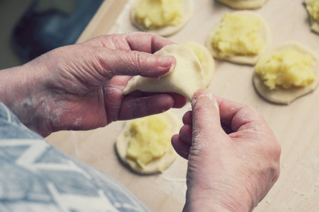 Close up of female hands making Polish dumplingsの写真素材