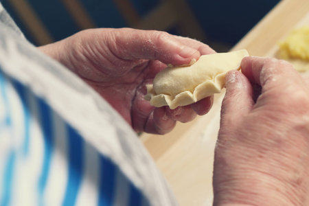 Close up of female hands making Polish dumplingsの写真素材
