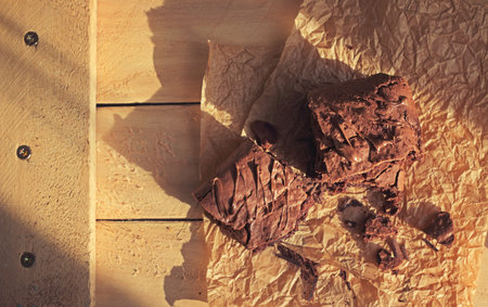 Homemade square brownies cut in pieces top view on a sunny day rustic styleの写真素材