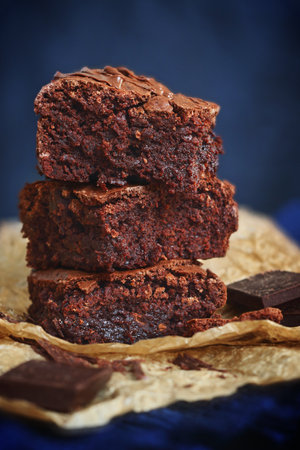 Three pieces of fudge brownies on blue backgroundの写真素材