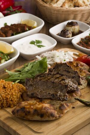 Sliced grilled steak roastbeef and onion on wooden cutting board backgroundの写真素材