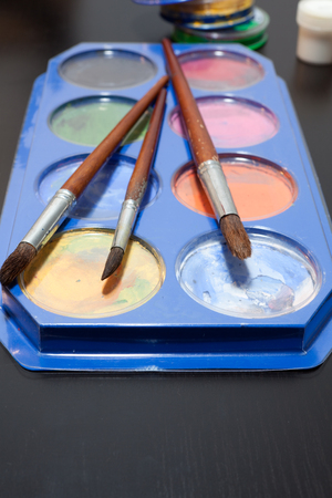 brushes and colored paint artist on grayの写真素材