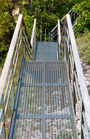 Iron staircase leading down to the forest