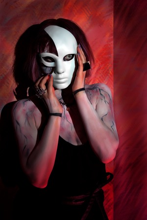 girl with zombie makeup on body and white mask on his face