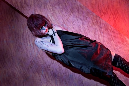 girl with zombie make up in black dress on red wallの写真素材
