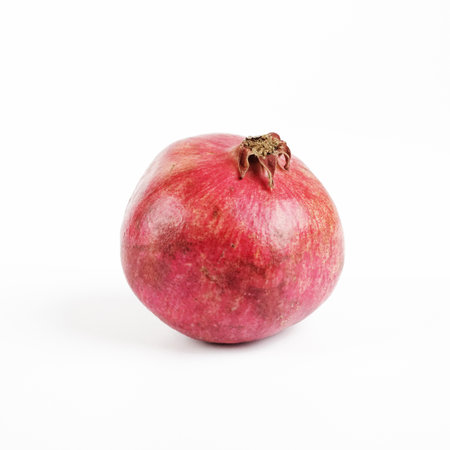 Ripe pomegranate fruit isolated on a white background.