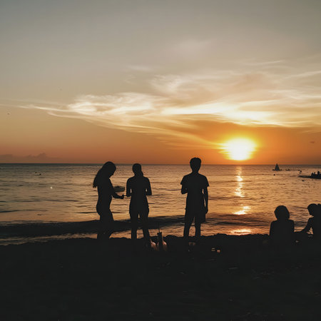 A group of friends stand in silhouette against the vibrant colors of a sunset on a beach.