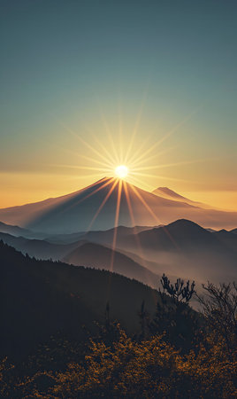 A stunning sunrise over a mountain range, showing the golden light illuminating the peaks and...