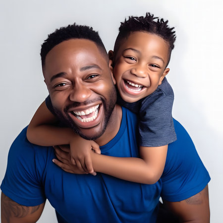 A portrait of a happy father and son laughing together. They are embracing and having a joyful moment.の素材