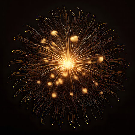 A mesmerizing golden fireworks display explodes against a dark night sky. The vibrant sparks illuminate the scene with a dazzling spectacle.の写真素材